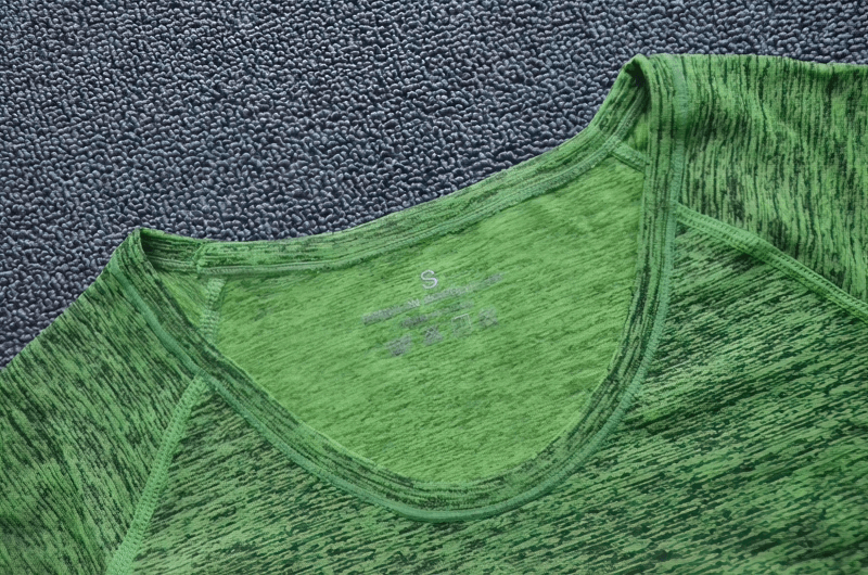 Close-up of breathable green women's short sleeve quick dry sports t-shirt neckline, perfect for yoga and running.